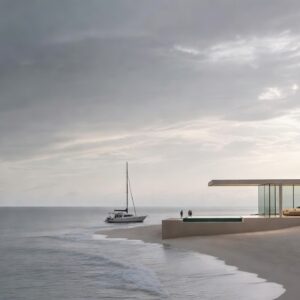 A minimalist modern white villa with a cantilevered roof and infinity pool on a wide white-sand beach under a misty gray sky with a sailing yacht in the distance.